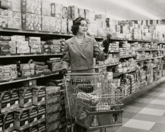 Young woman with a shopping cart in a grocery store Canvas Art - (24 x 36)