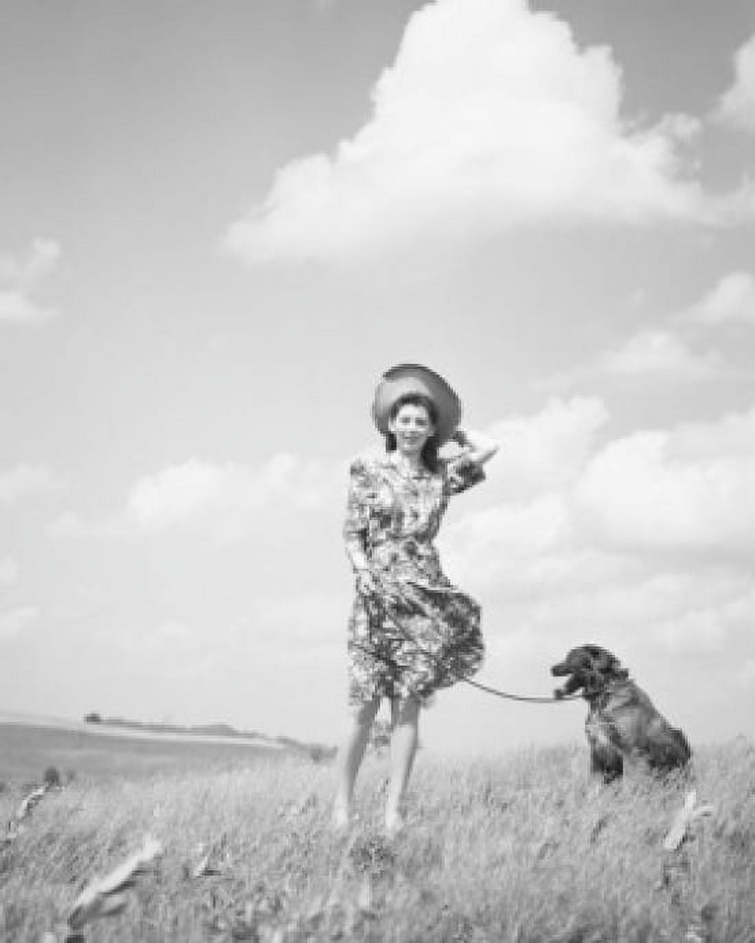 Young woman with dog in meadow Canvas Art - (24 x 36)