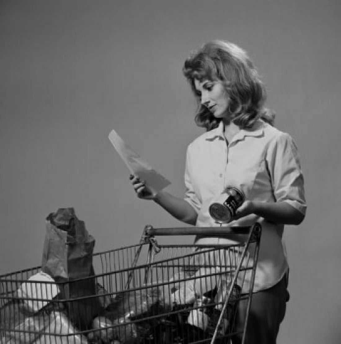 Young woman with groceries in shopping trolley Canvas Art - (18 x 24)