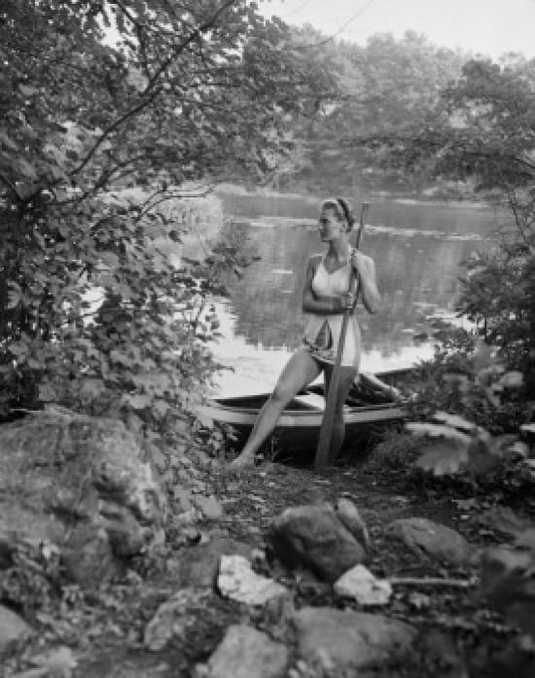 Young woman with oar standing on lakeshore Canvas Art - (24 x 36)