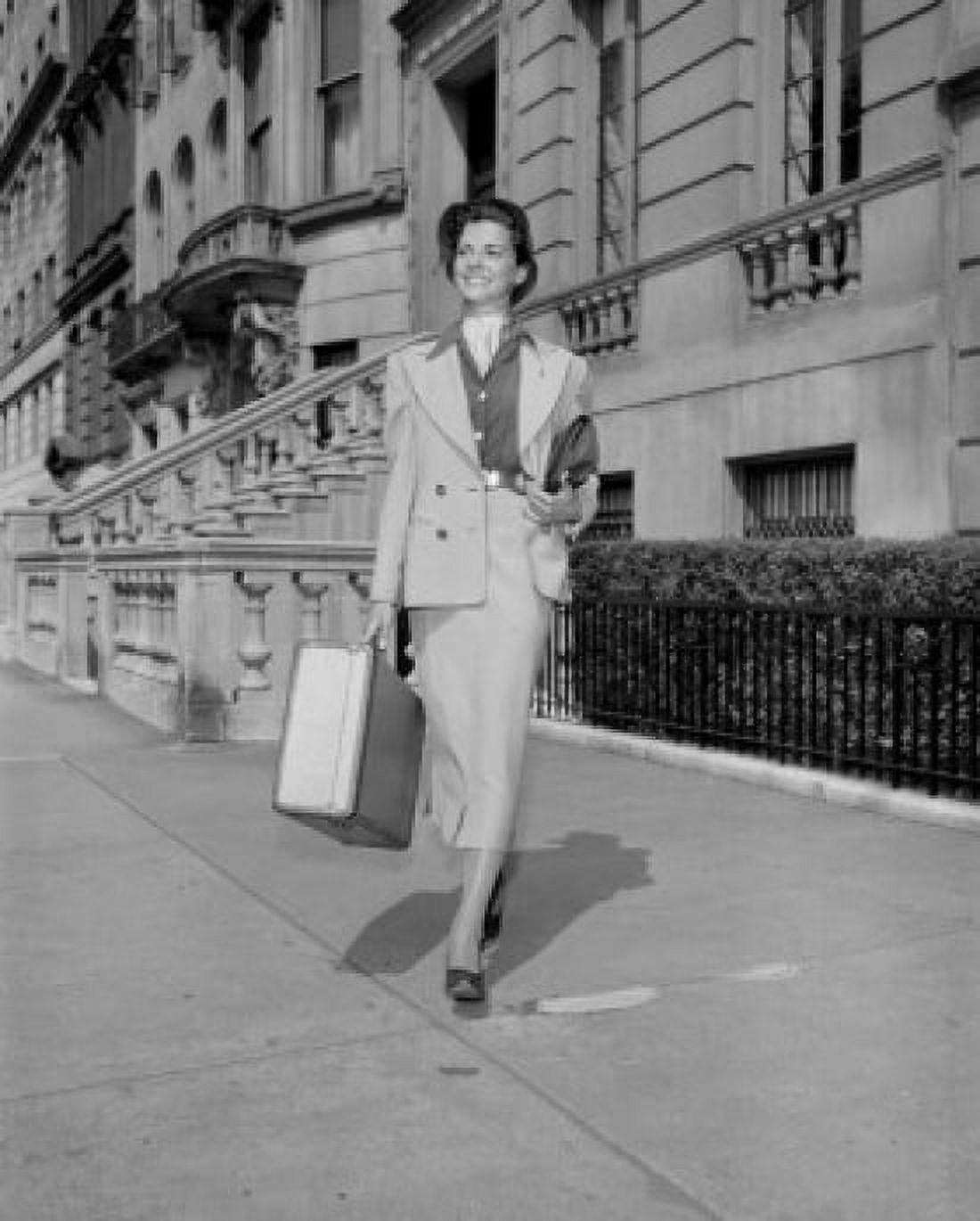Young woman with suitcase walking on sidewalk Canvas Art - (24 x 36)