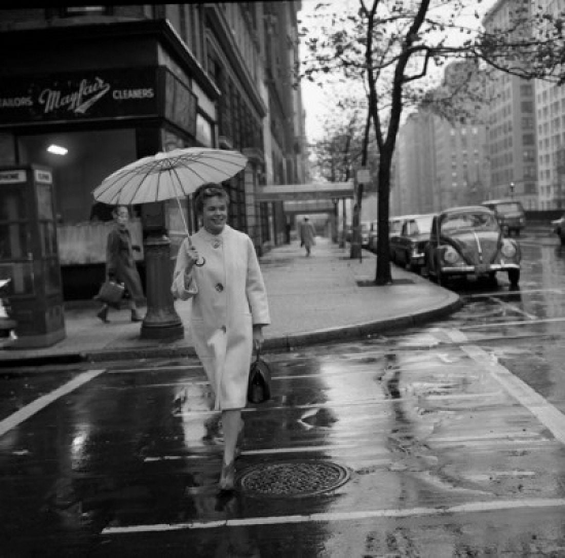 Young woman with umbrella crossing street in rain Canvas Art - (24 x 36)