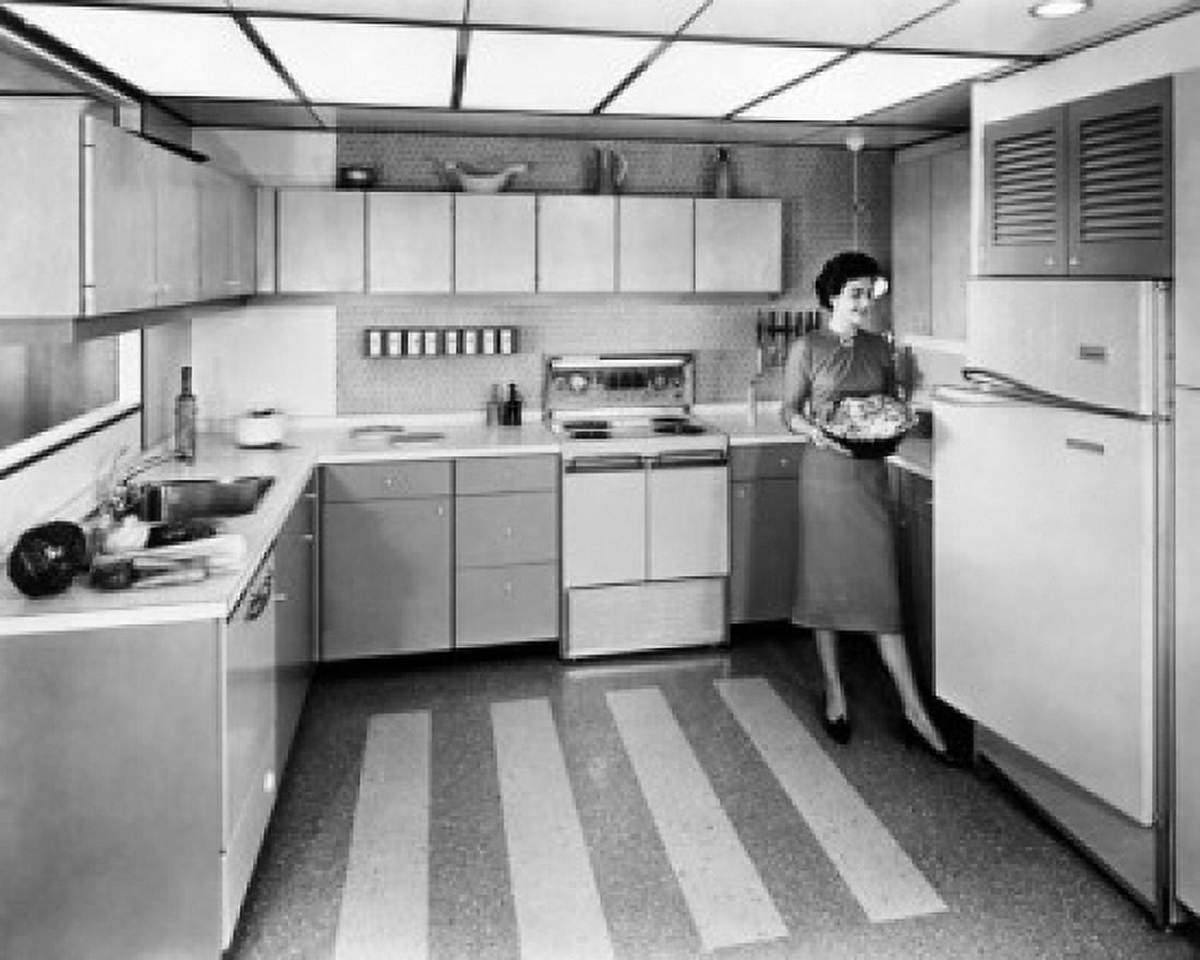 Young woman working in a kitchen Canvas Art - (18 x 24)
