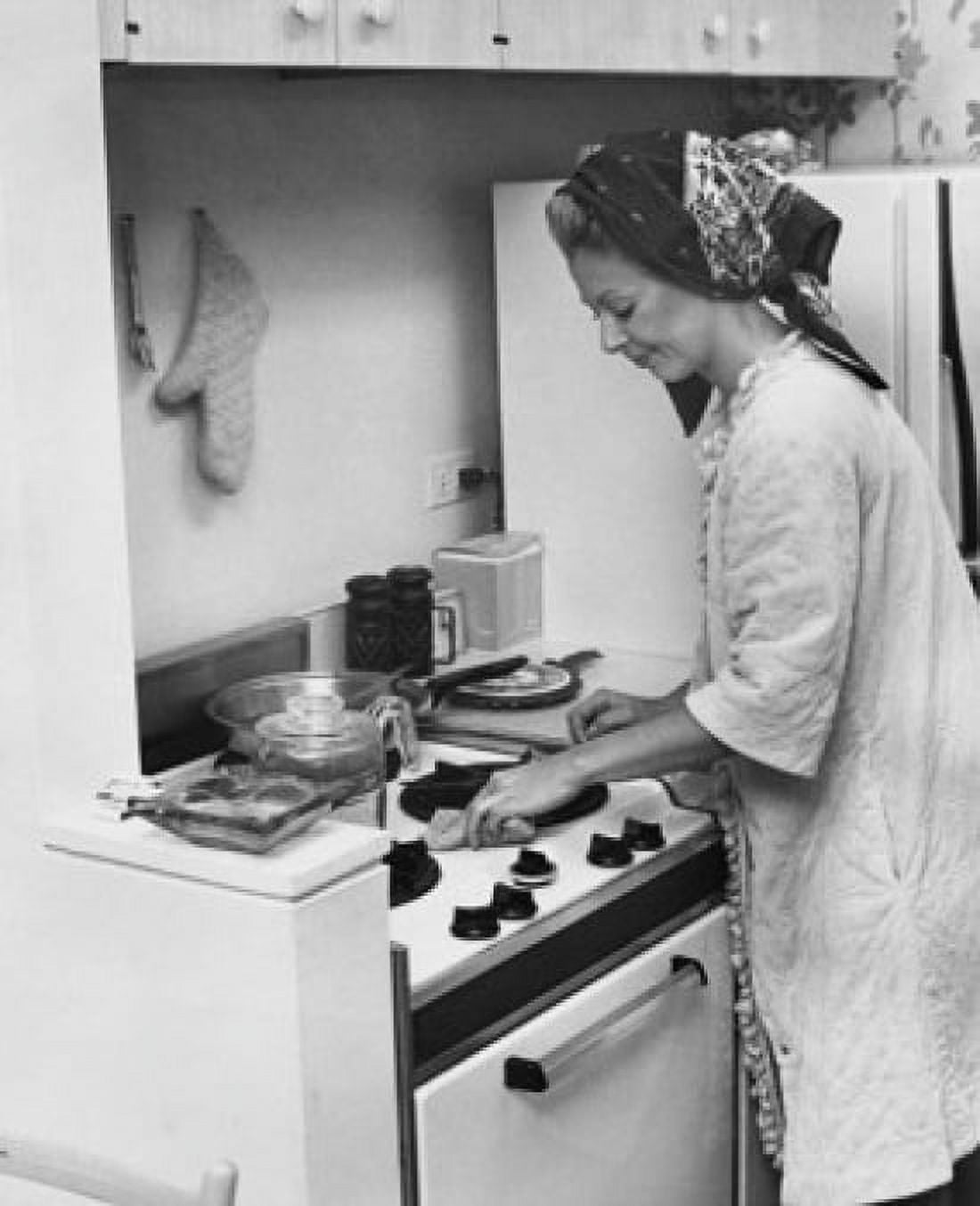 Young woman working in a kitchen Canvas Art - (18 x 24)