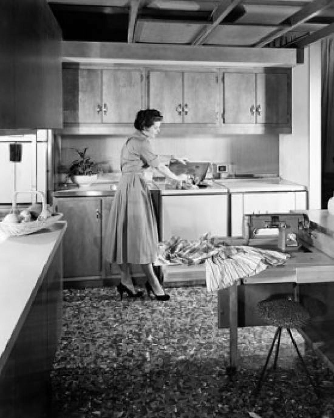 Young woman working in a kitchen Canvas Art - (24 x 36)