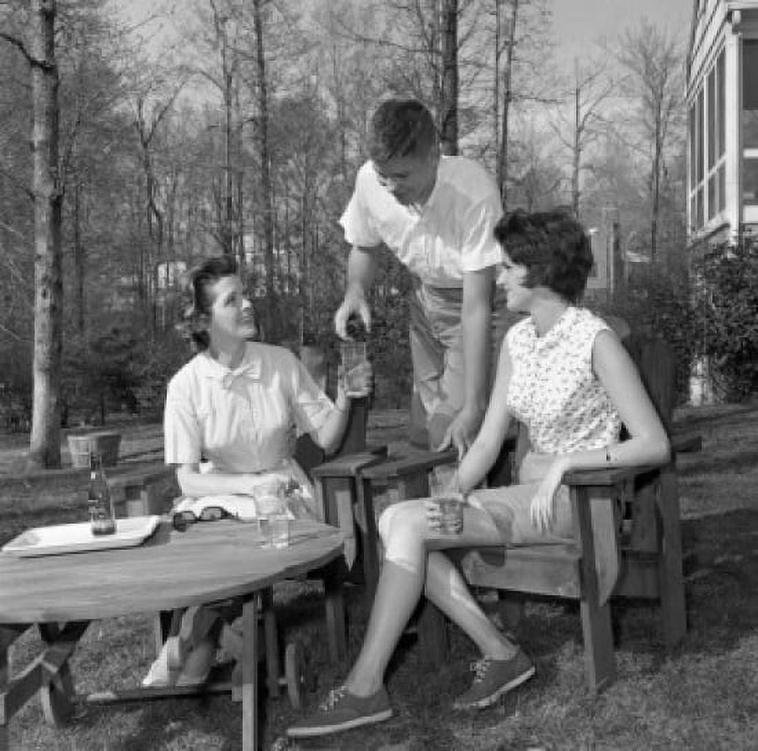 Young women and young man sitting in backyard and drinking water Canvas Art - (24 x 36)