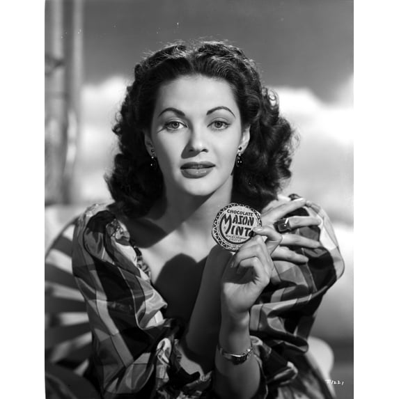 Yvonne Decarlo posed in A Portrait Holding A Mason Mints Badge in Black and White Photo Print (8 x 10)