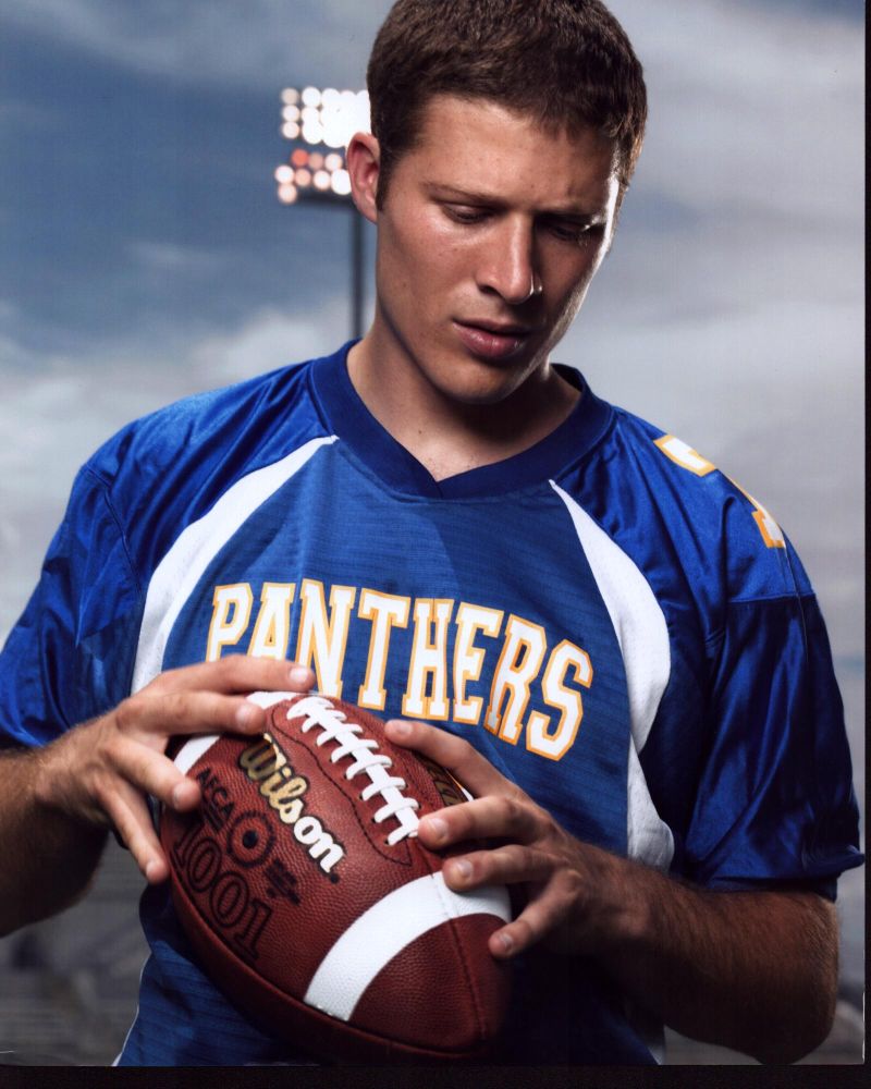 Zach Gilford Holding Football In Panthers Jersey In Friday Night Lights
