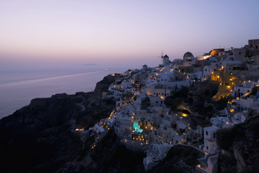 An aerial view of Oia and the windmill at dusk Oia Santorini The Cyclades The Aegean The Greek Islands Greece Canvas Art - Ellen Rooney Design Pics (36 x 24)