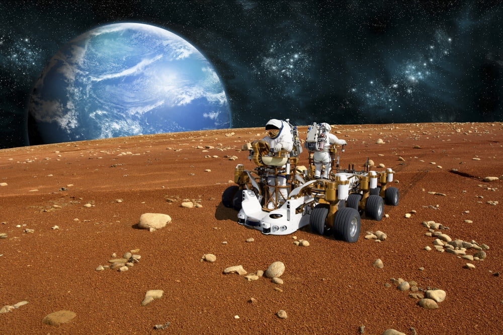 astronauts explore a barren moon on a rover Canvas Art - Marc WardStocktrek Images (34 x 23)