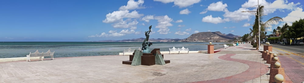 The beachside strolling Malecon and statue is of a mermaid and three dolphins La Paz Baja California Sur Mexico Canvas Art - Panoramic Images (44 x 12)