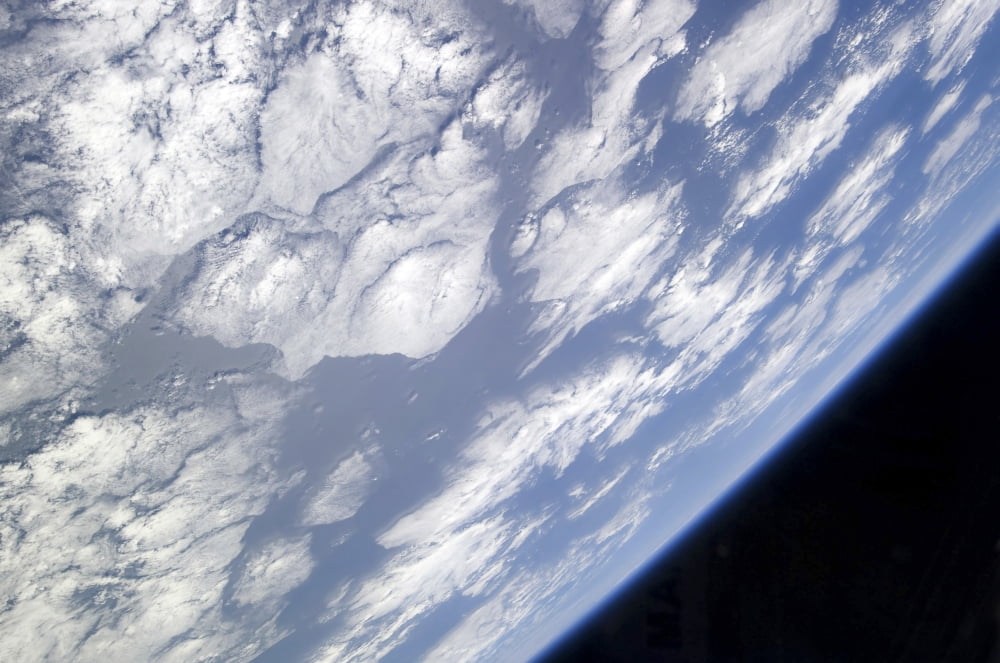 A blue and white part of Earth and the blackness of space viewed from the Earth-orbiting space shuttle Atlantis Canvas Art - Stocktrek Images (34 x 23)