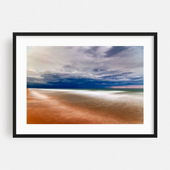 The blurred movement of waves creates a serene and contemplative atmosphere on the sandy beach. - Valencia Valencian Community Spain Photography Seascape Black Framed Wall Art Print 24 x 36 inches