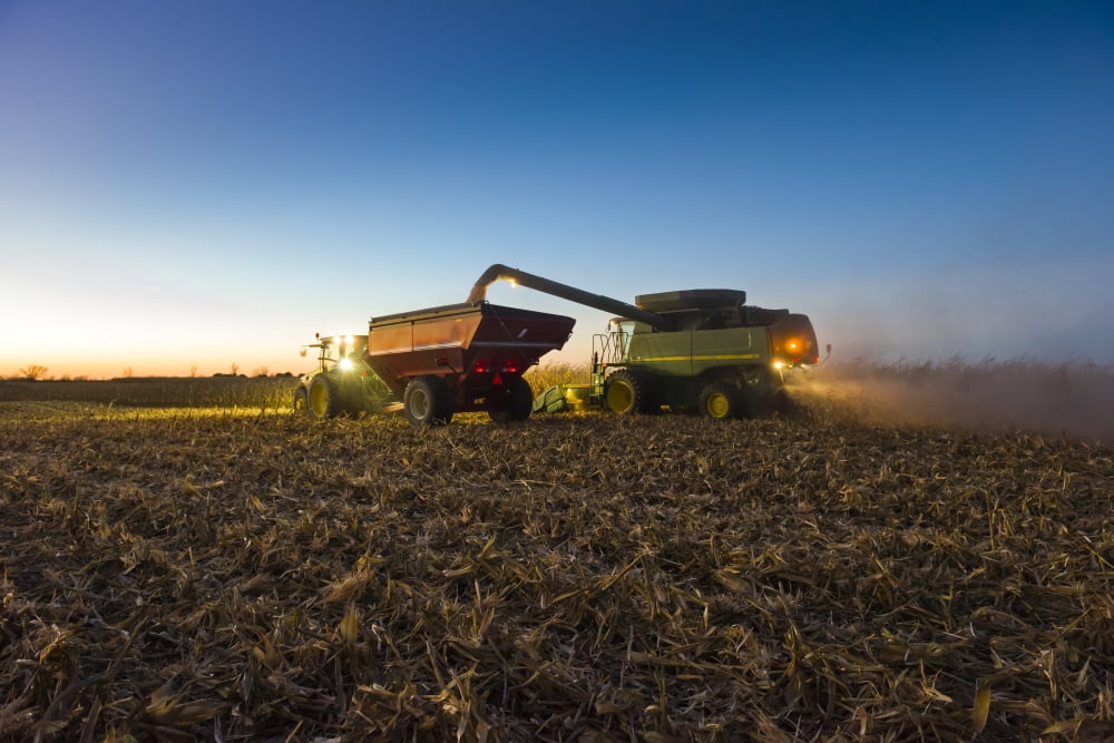 A farmer augers yellow grain corn from his combine into a grain wagon at night in Southern Iowa Iowa United States of America Canvas Art - Scott Sinklier Design Pics (19 x 12)