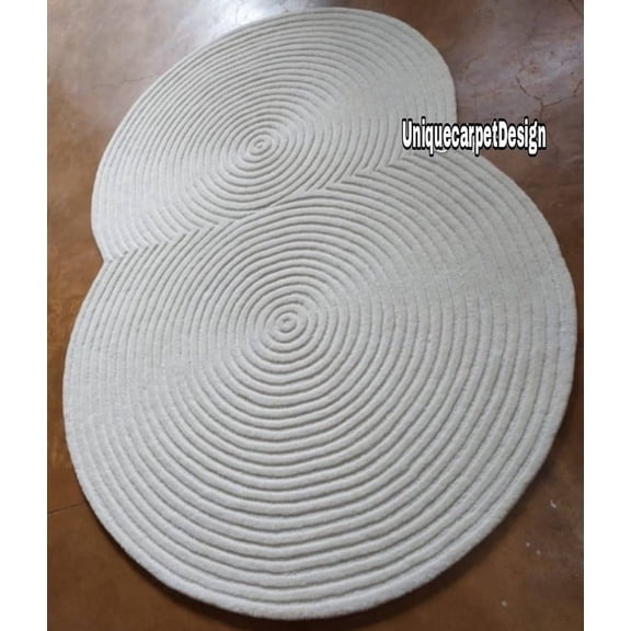 A handmade tufted woolen rug with a pile cut and loop design in white typically features a combination of different textures and looks, giving it a distinct appearance. ,Custom size accept,