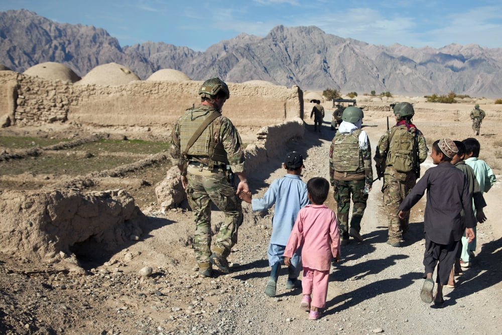 hildren walk alongside coalition force members in Afghanistan Canvas Art - Stocktrek Images (35 x 23)