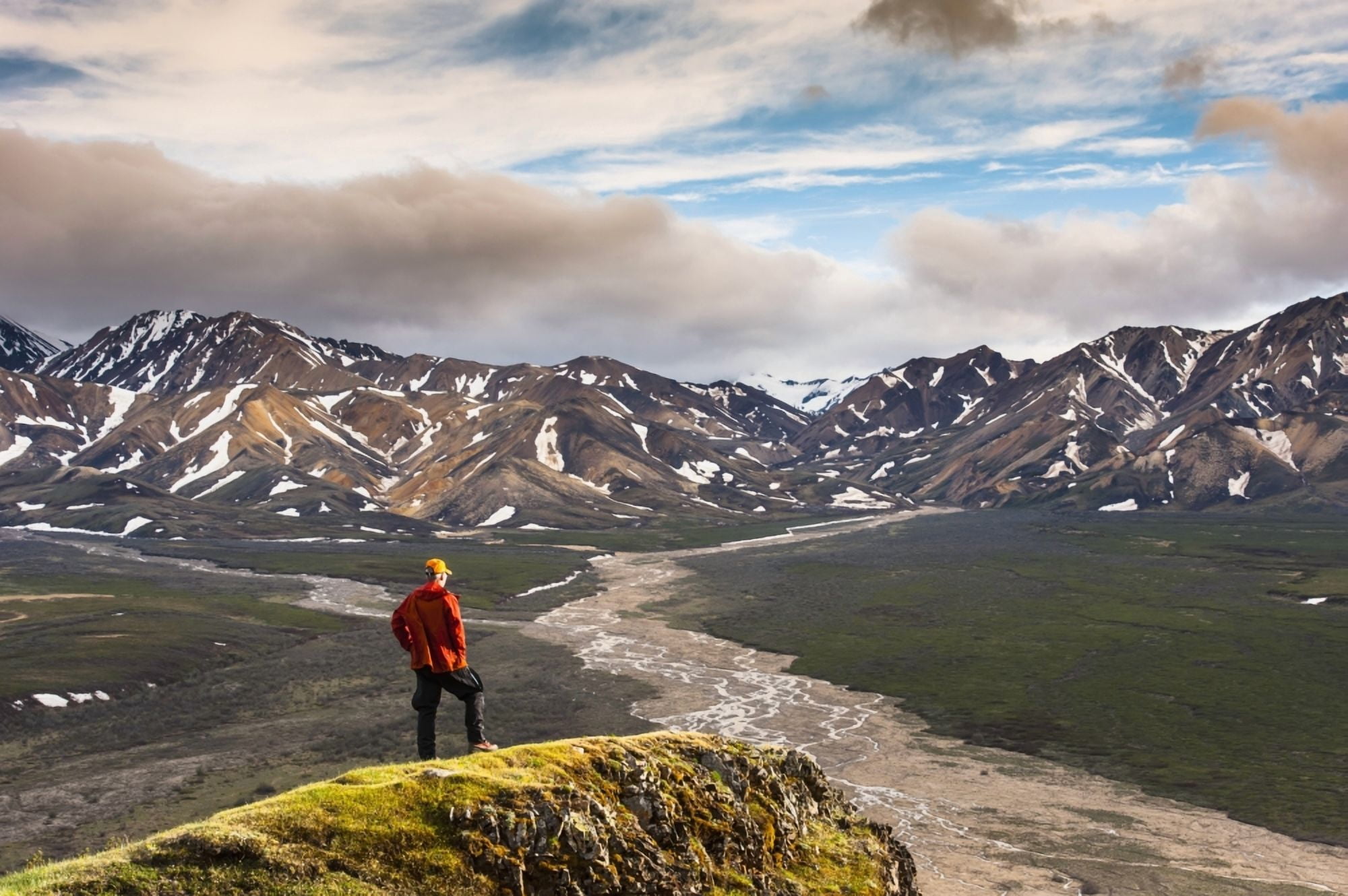 A man standing on a bluff at Polychome Pass with the Plains of Murie and the Alaska Range in the background Denali National Park Interior Alaska Canvas Art - Michael Jones Design Pics (38 x 24)
