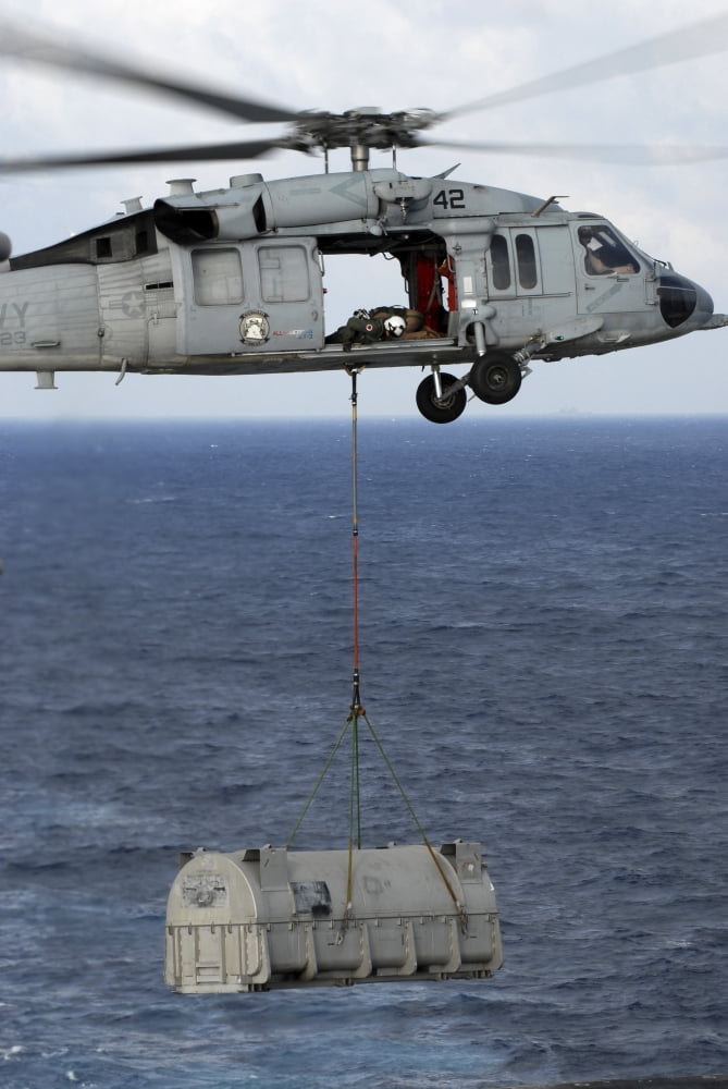 n MH-60S Sea Hawk en route with a shipment of supplies during a vertical replenishment at sea Canvas Art - Stocktrek Images (23 x 35)