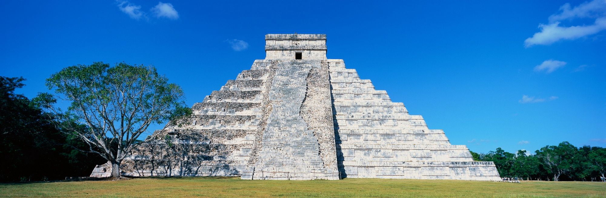 A panoramic view of the Mayan Pyramid of Kukulkan (also known as El Castillo) and ruins at Chichen Itza Yucatan Peninsula Mexico Canvas Art - Panoramic Images (27 x 9)