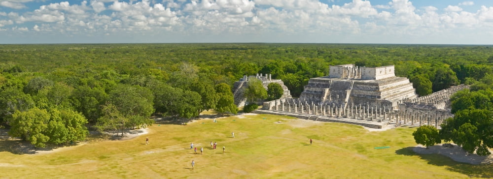 A panoramic view of the Temple of the Warriors out of jungle at Chichen-Itza A Mayan ruin in the Yucatan Peninsula Mexico Canvas Art - Panoramic Images (36 x 12)