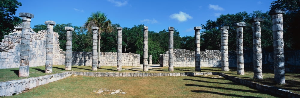 A panoramic view of columns surround grassy courtyard for ballgames at Chichen Itza Mayan Ruins in the Yucatan Peninsula Mexico Canvas Art - Panoramic Images (27 x 9)