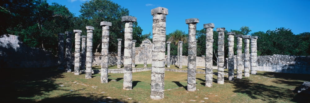 A panoramic view of columns surround grassy courtyard for ballgames at Chichen Itza Mayan Ruins in the Yucatan Peninsula Mexico Canvas Art - Panoramic Images (36 x 12)