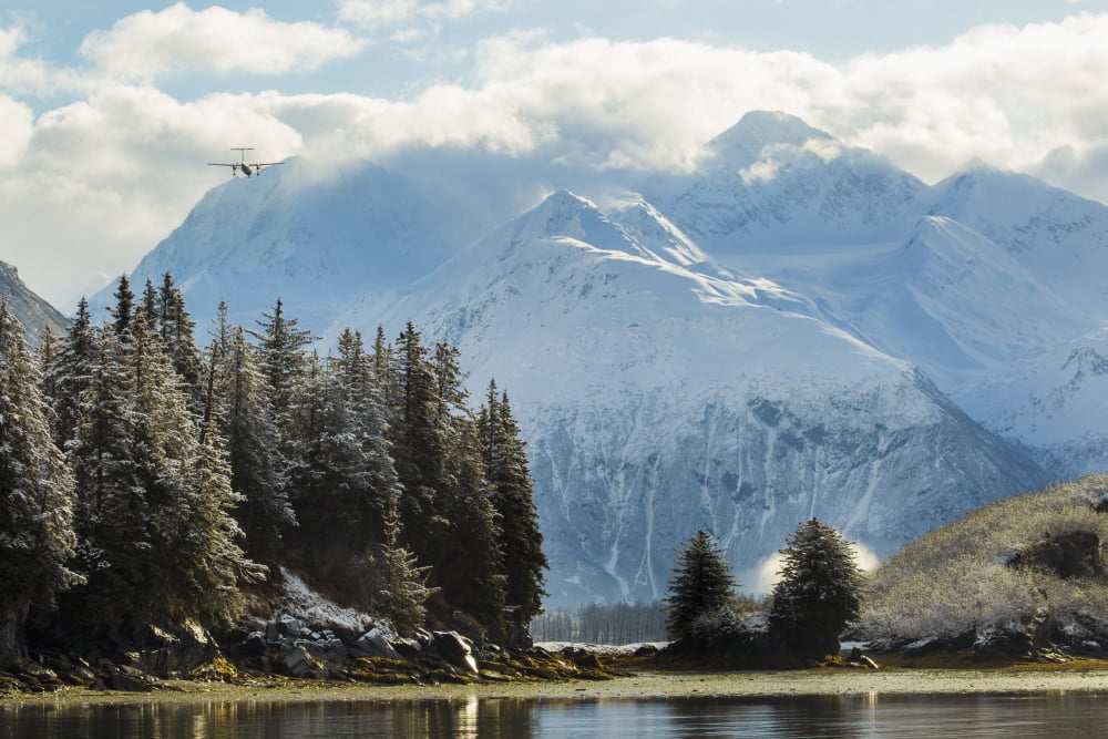 A plane comes in for a landing at Valdez Airport while flying over Dock Point Alaska United States of America Canvas Art - Zachary Sheldon Design Pics (19 x 12)