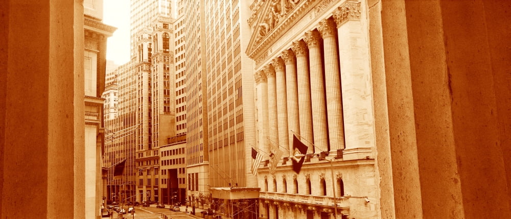 This is a sepiatone view looking at the exterior of the New York Stock Exchange on Wall Street It is framed by two white columns Canvas Art - Panoramic Images (27 x 9)