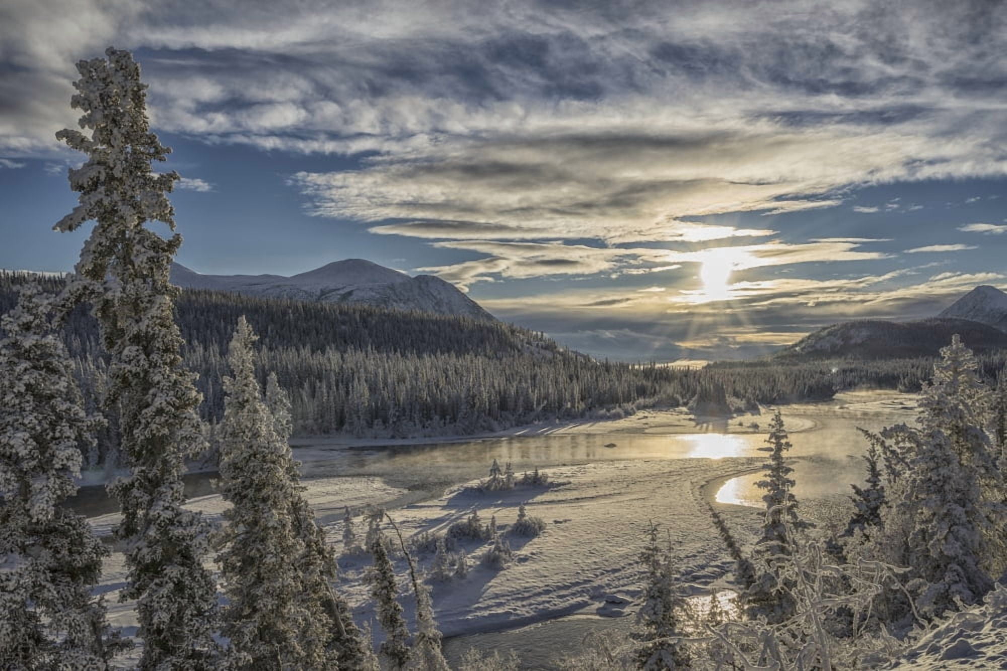 The sun breaks through the clouds above the Takhini River on a late winter afternoon near Whitehorse Yukon Canada Canvas Art - Robert Postma Design Pics (19 x 12)