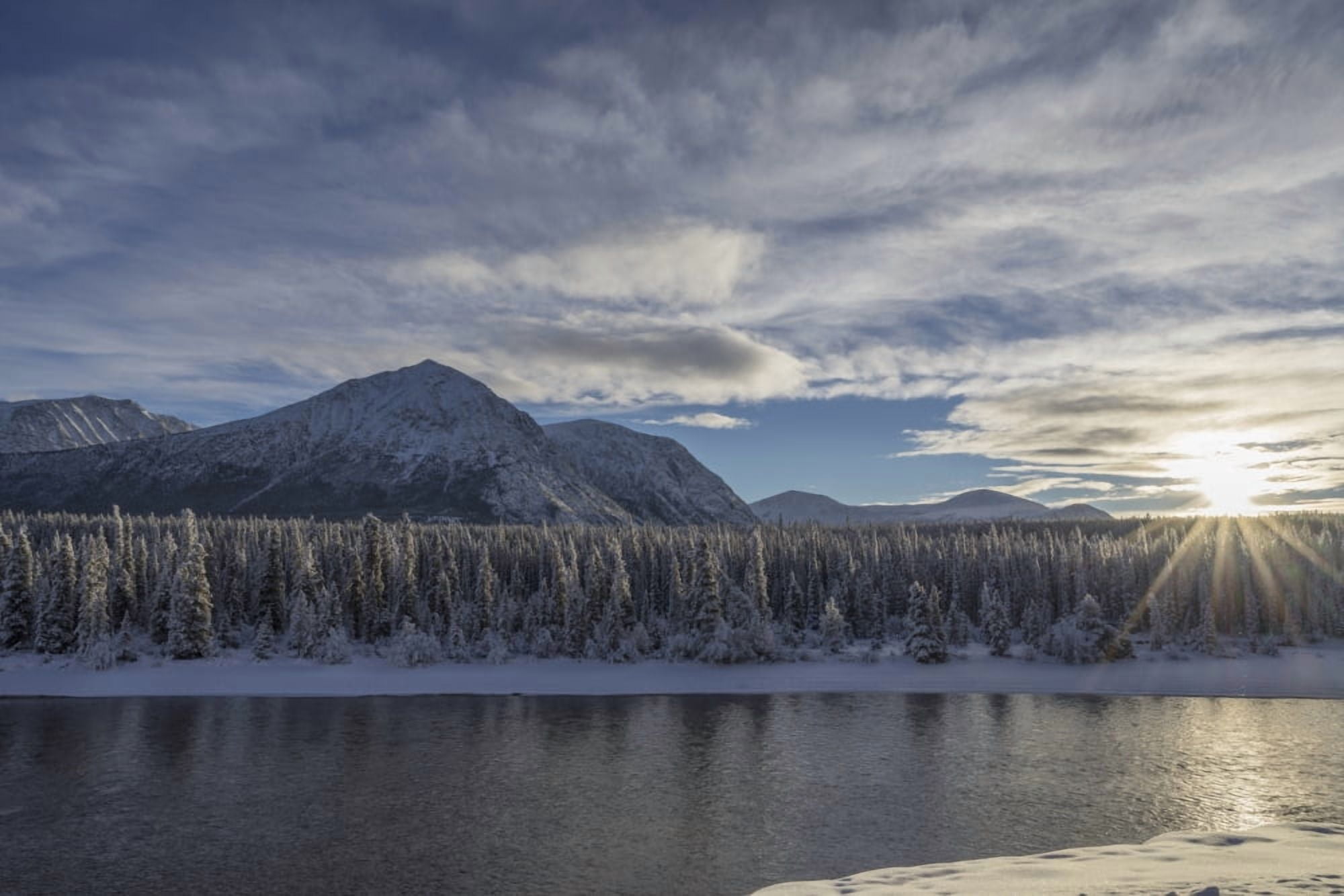 The sun breaks through the clouds above the Takhini River on a late winter afternoon near Whitehorse Yukon Canada Canvas Art - Robert Postma Design Pics (19 x 12)