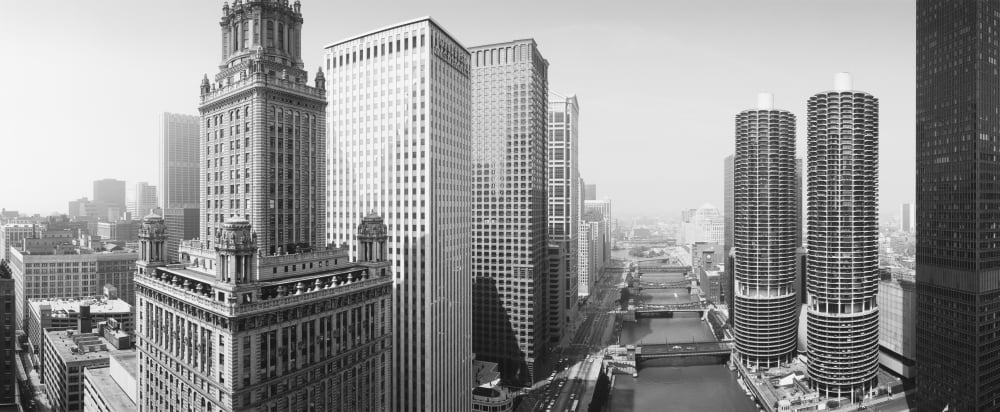 This is a view looking over the Chicago River The Marina Tower Apartments the Wrigley Building and the skyline surround the river It is a black and white shot Canvas Art - Panoramic Images (27 x 9)