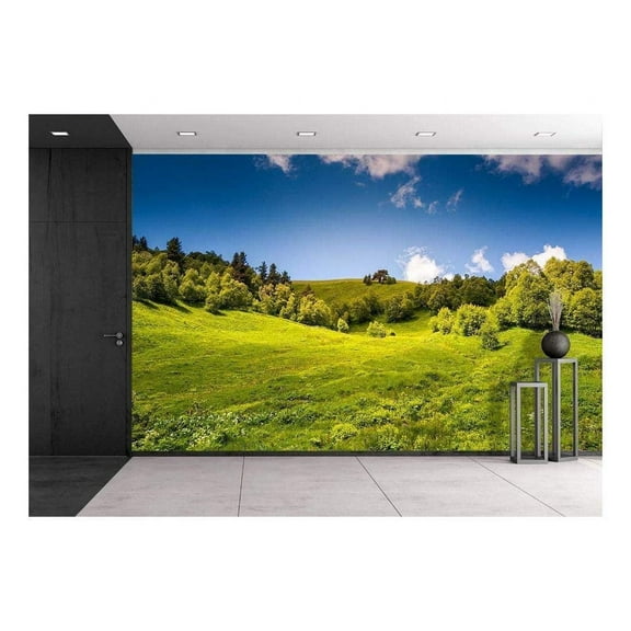 wall26 - Beautiful View of Rural Alpine Landscape. Sunny Hills Under Cloudy Sky - Removable Wall Mural | Self-Adhesive Large Wallpaper - 100x144 inches