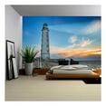 thumbnail image 1 of wall26 - Lighthouse Searchlight Beam Through Sea Air at Night. Seascape at Sunset - Removable Wall Mural | Self-Adhesive Large Wallpaper - 66x96 inches, 1 of 6