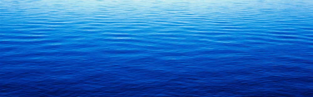 These are water reflections in Lake Tahoe The water is a deep blue and the small ripples in the water form a pattern Canvas Art - Panoramic Images (36 x 12)